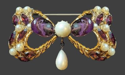 Bow design gold tone faux pearls rhinestone brooch with pearl charm. 1960s. Adrian Mann vintage costume jewelry