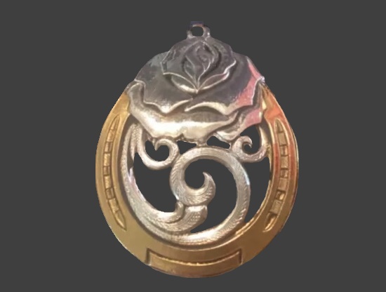 Gold and silver tone metal open work design pendant
